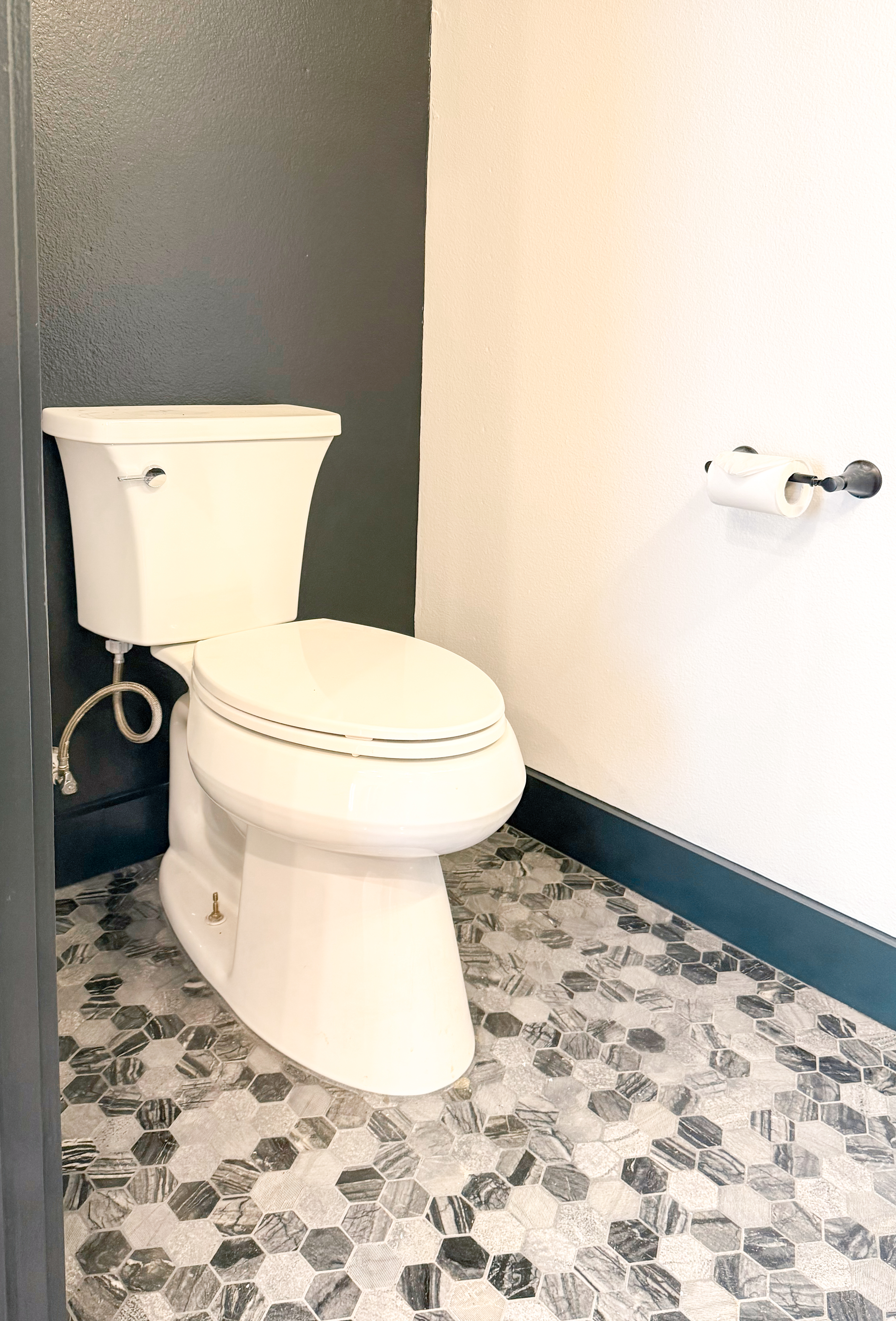 Downstairs half bathroom with tile flooring.